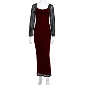 Detail of burgundy velvet dress featuring elegant black mesh sleeves and hemline inserts