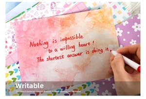 Macro view of pink gradient watercolor scrapbook paper with handwritten aesthetic quotes