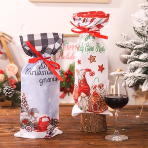Christmas gnome wine bottle gift bags with Santa patterns and festive ribbon decorations