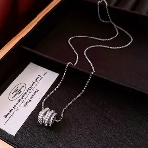 Minimalist silver round hollow necklace with pavé cubic zirconia on a jewelry display tray