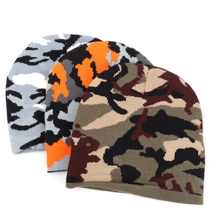 Detailed knit texture of three camouflage beanies in grey, orange, and green patterns