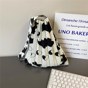 Foldable pleated knit handbag with black and white heart pattern and cow print design