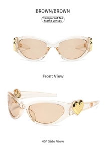 Detail view of transparent brown cat-eye sunglasses with golden heart-shaped metal hinge