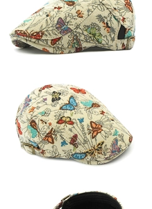 Detail view of ethnic jacquard beret with butterfly patterns and metal side buckle