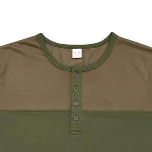Detailed view of the buttoned Henley neckline and contrast stitching on the long sleeve T-shirt