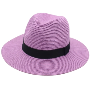 Detail of lilac purple straw Panama hat featuring dense spiral weave and black ribbon band