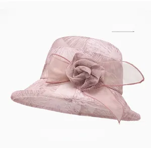 Detail of light pink summer sun hat featuring delicate mesh flower and leaf texture fabric