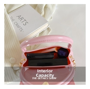 Internal capacity of mini pink jelly bag showing space for cosmetics and essentials