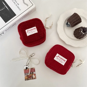 Minimalist plush storage pouch in deep red with pearl bow heart pendant and label