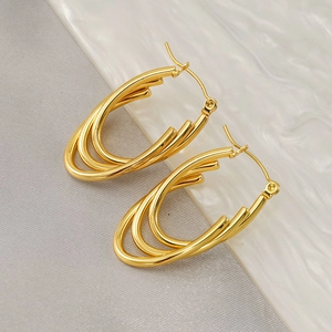 Elegant 18K gold layered oval earrings in stainless steel on white marble background