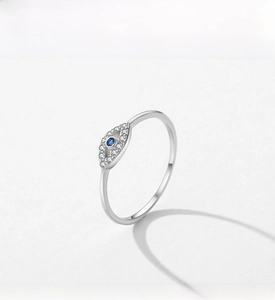 Macro shot of S925 sterling silver evil eye ring with blue stone and pavé zircons