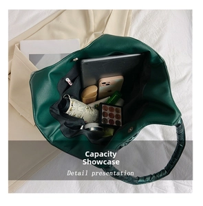 Deep green tote bag with padded texture showing large capacity for tablet and daily items