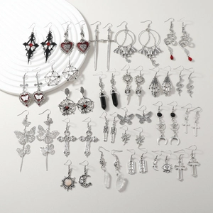 Lot de boucles d'oreilles gothiques en alliage avec serpents et croix sur fond blanc