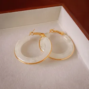 Vintage hollow gold-plated resin hoop earrings with marble texture for a luxury look