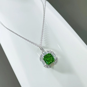 Macro detail of a square green gemstone necklace with silver micro-pave diamond halo