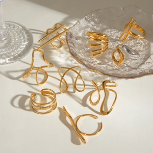 Artistic golden irregular wavy line rings on a textured glass surface detail