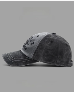 Detail of washed charcoal grey baseball cap with letter embroidery and contrast stitching
