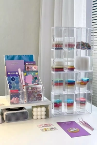 Detailed view of clear acrylic desk organizer filled with colorful stickers and stationery