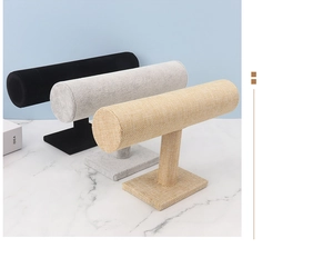 Three-tier T-bar jewelry display stands in black velvet, grey flocking, and yellow linen