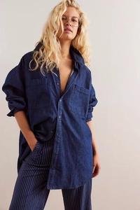 Detailed view of women's loose retro denim shirt with twin chest pockets in dark blue