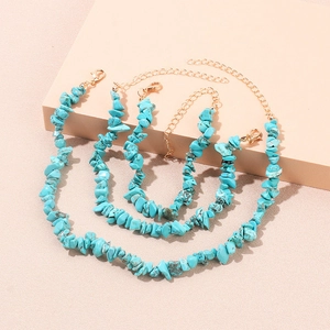 Detailed shot of four natural turquoise stone necklaces with gold lobster clasps and chains