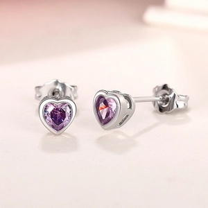 Detailed side view of silver heart earring featuring a purple gemstone and butterfly back