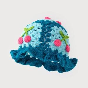 Handmade crochet baby sun hat with cute cherry detail and blue ruffle brim