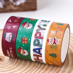 Set of 4 Christmas washi tapes with Santa and snowman patterns on wooden background