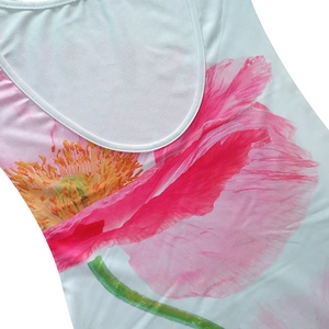 Detail shot of the U-neck collar and vibrant pink poppy flower print on the sleeveless dress