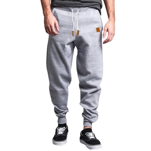 Detail of light gray joggers with adjustable white drawstring and ribbed ankle cuffs