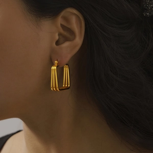 Vintage geometric layered gold plated titanium steel earrings on a female model