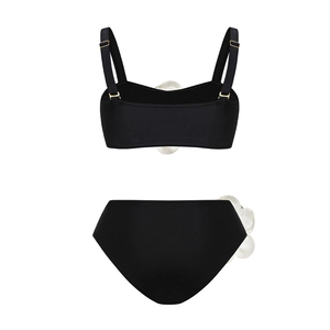 Detail view of black bikini top with adjustable straps and 3D floral accents