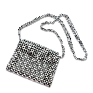 Detailed close-up of handmade silver beaded crossbody bag with metallic woven texture
