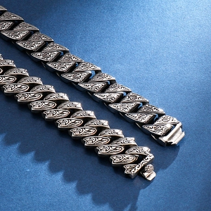 Macro shot of retro stainless steel cuban chain with engraved patterns and snap clasp