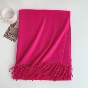 Detailed view of rose red imitation cashmere scarf with soft fringe and stylish drape