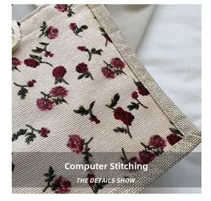 Macro shot of precise computerized stitching on floral canvas bag with rose pattern