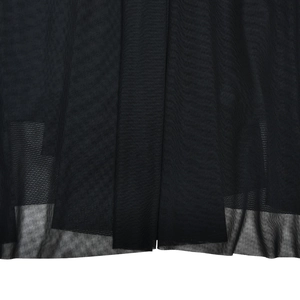 Close-up of black mesh fabric detail showing pleated texture and semi-transparent layers