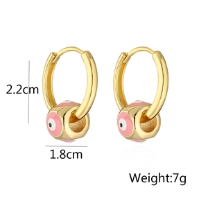 Detailed view of gold-plated evil eye hoop earrings with pink and white enamel charms