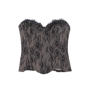 Close-up of black lace corset top with nude lining and delicate eyelash lace edges