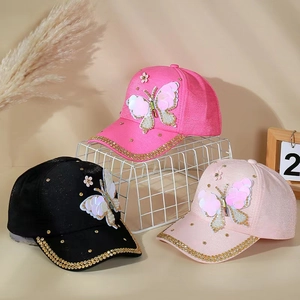 Detail of sequin butterfly embroidery and rhinestones on colorful baseball caps