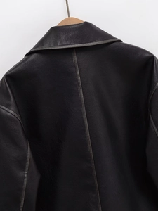 Detail view of the back seam and collar on a premium black leather motorcycle jacket