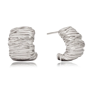 Detailed macro view of silver irregular C-shape earrings with textured woven metal finish