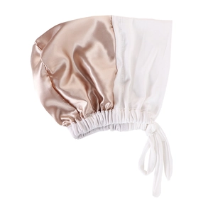 Detail of satin sleep bonnet with champagne gold and white color-block design