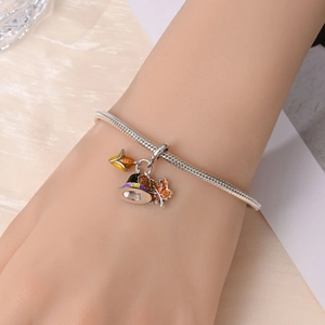 Close-up of 925 silver plated bracelet with autumn maple leaf and wizard hat charms
