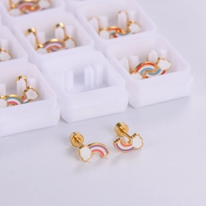 Detail of gold rainbow cloud stud earrings with screw backs in a white storage box