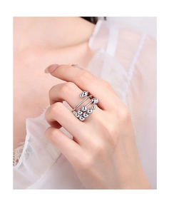 Close-up of adjustable silver rotating bead ring worn on finger for stress relief