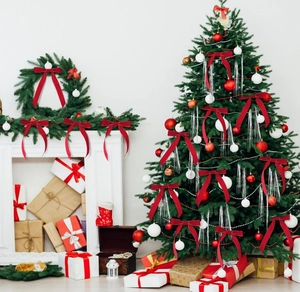 Red velvet Christmas bows displayed on a festive tree and gift boxes for holiday decor