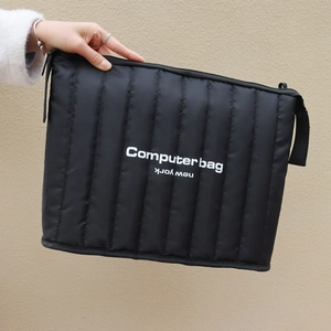 Quilted black nylon laptop bag with shoulder strap and New York print detail