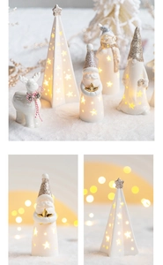Close-up of glowing ceramic Santa, reindeer and tree with sparkling glitter finish