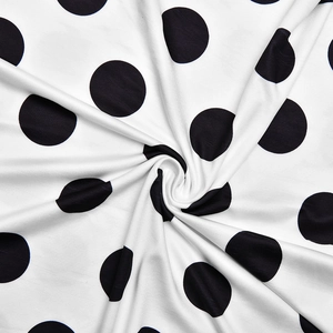 Macro view of polka dot fabric detail showing soft texture and draped pleated material